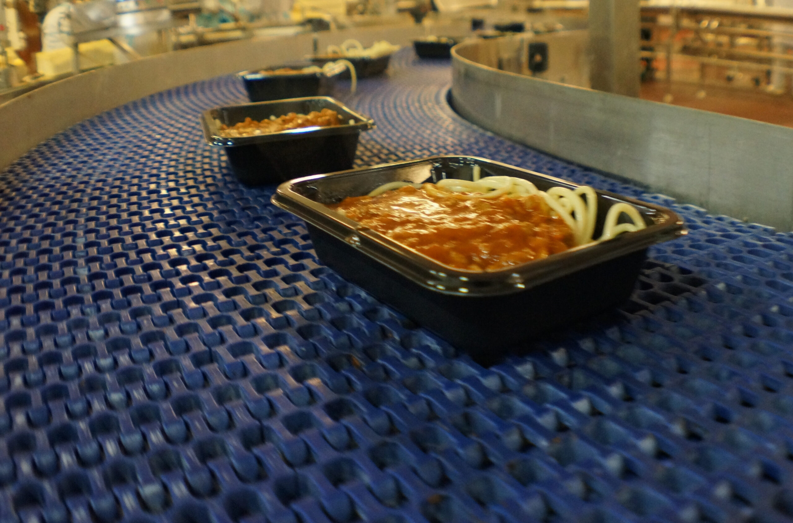 Factory Food Manufacturing Children's Spahetti Bolognaise being manufactured in a high speed factory process